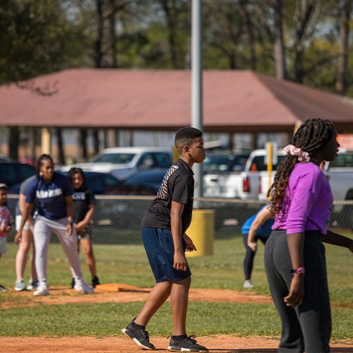 Kids playing at the park with coaches