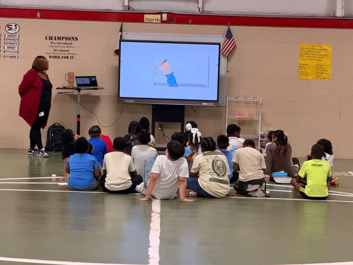 Students seated together during a Houston Crime Stoppers cyber-safety lesson