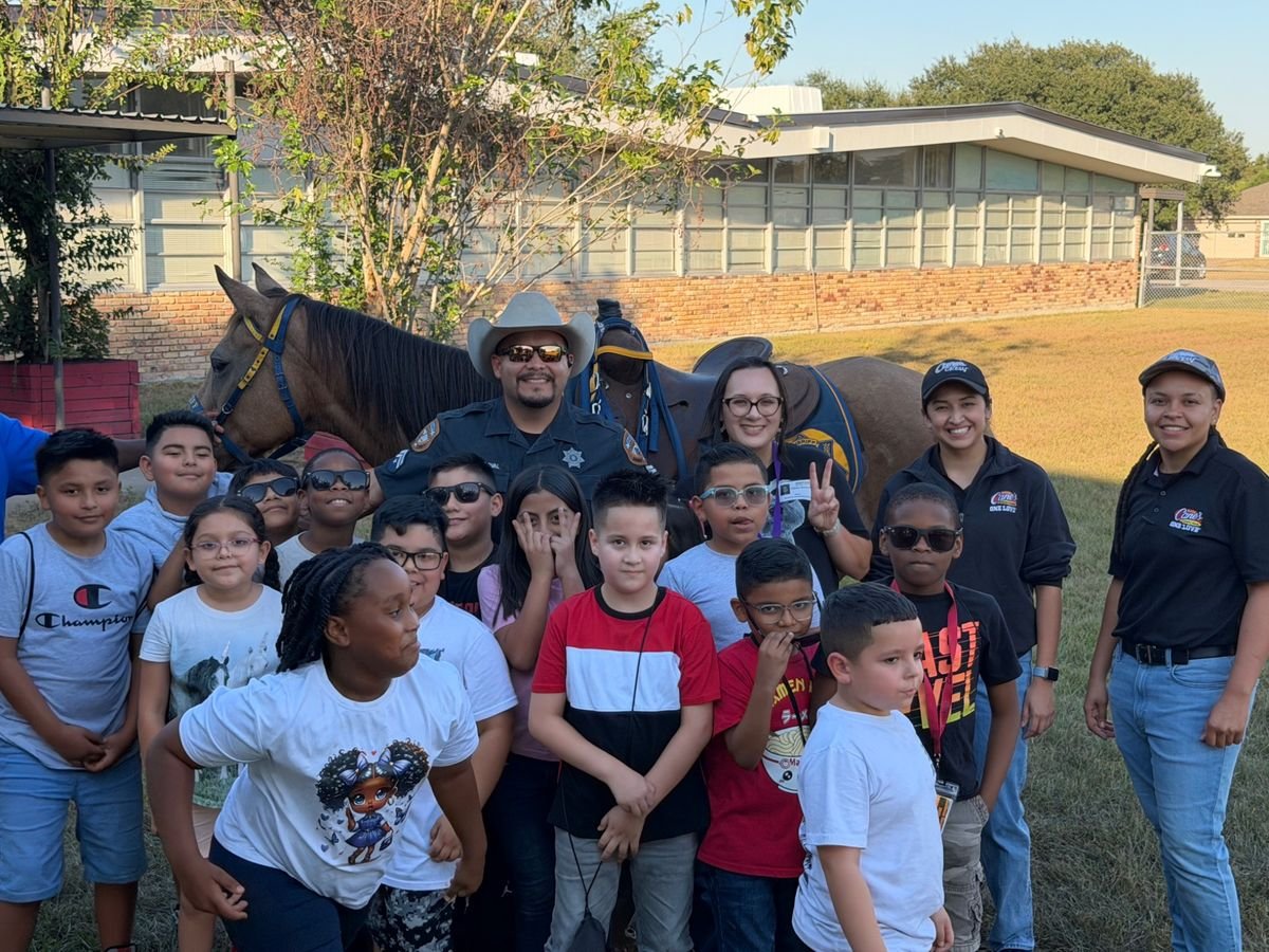 Students with the Harris County Sheriff’s Office Mounted Unit during a YES Community Program livestock activity