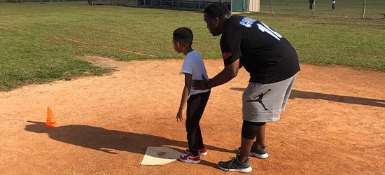 Coach guiding a young player